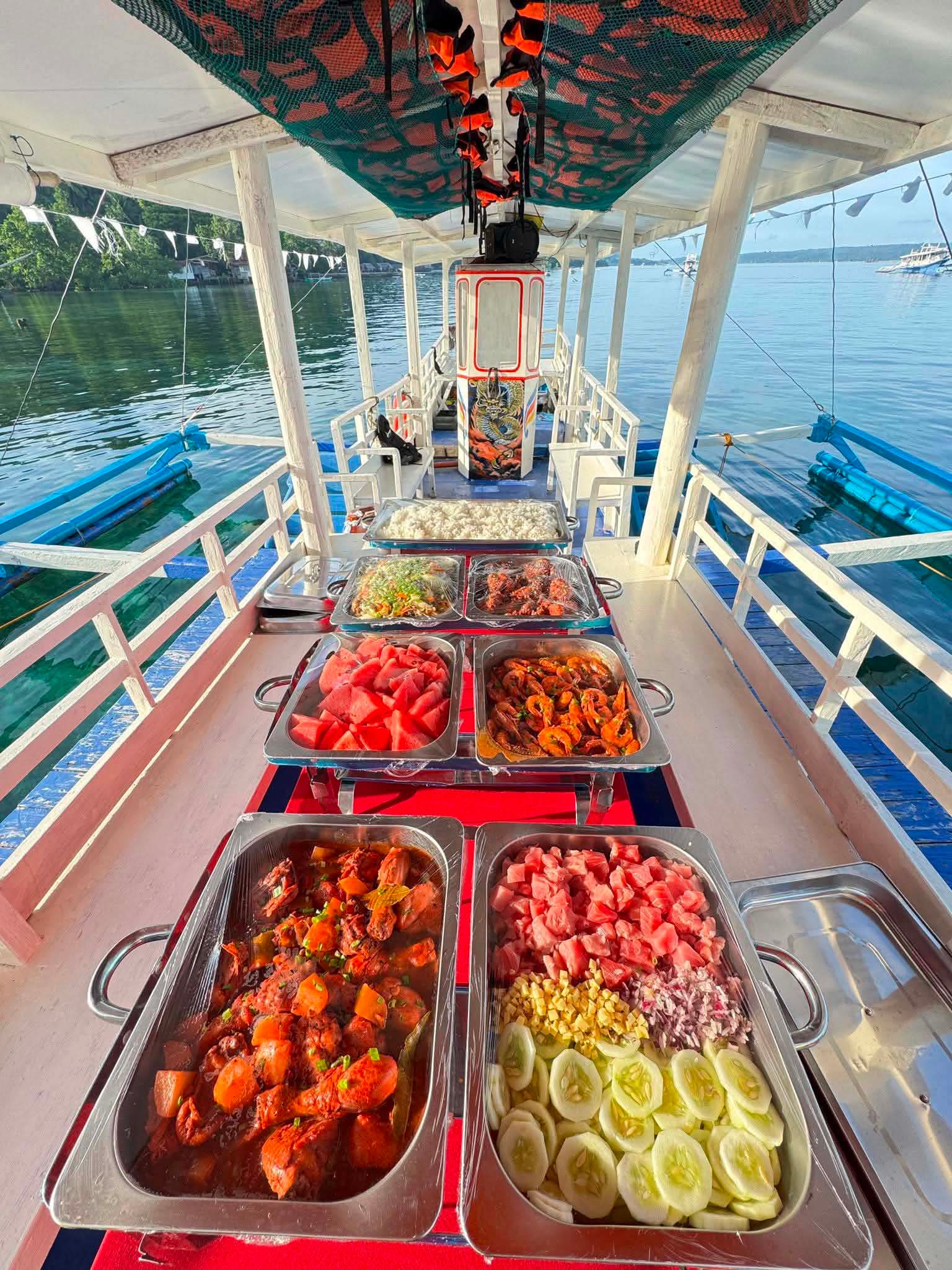 Full buffet spread laid out on the boat deck for guests